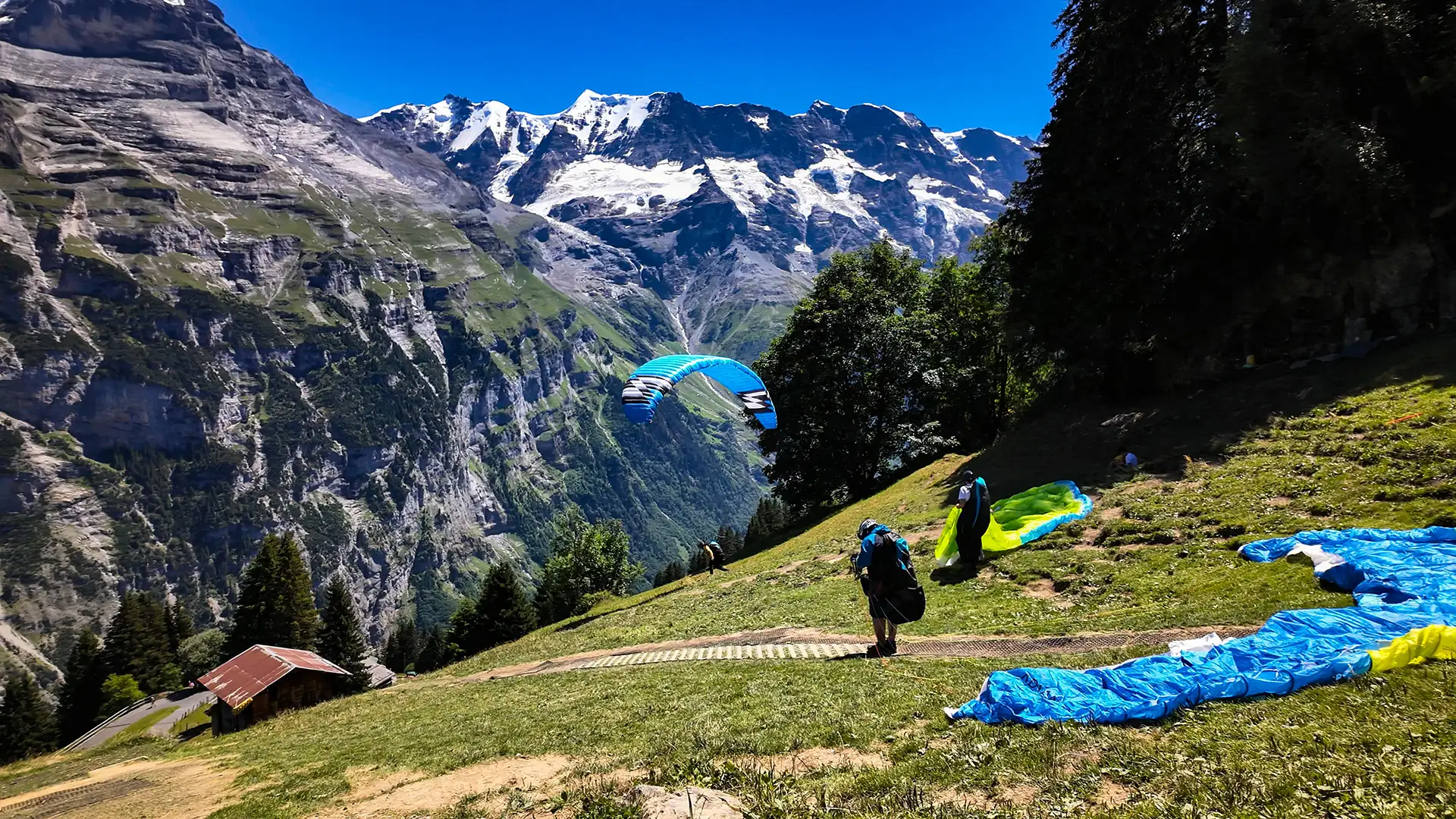 Paraglider taking off in the mountains